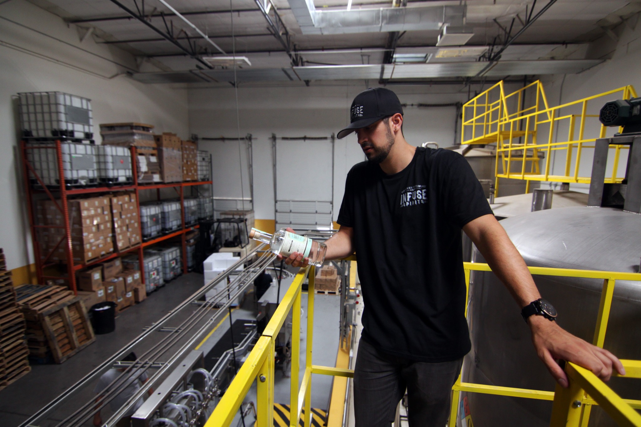 Seth inspecting a bottle on the Infuse Spirits production floor